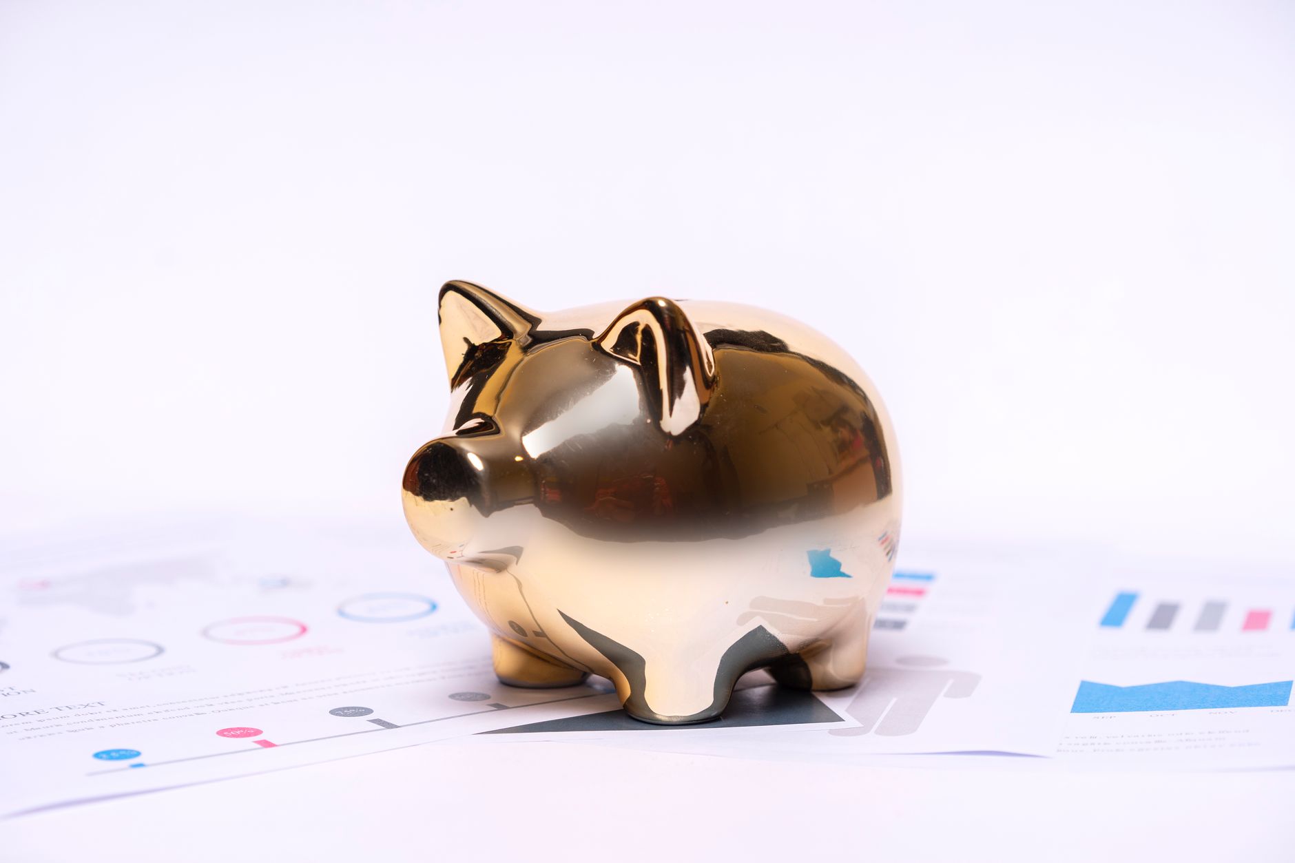 Stack of Japanese yen coins and banknotes beside a small pig