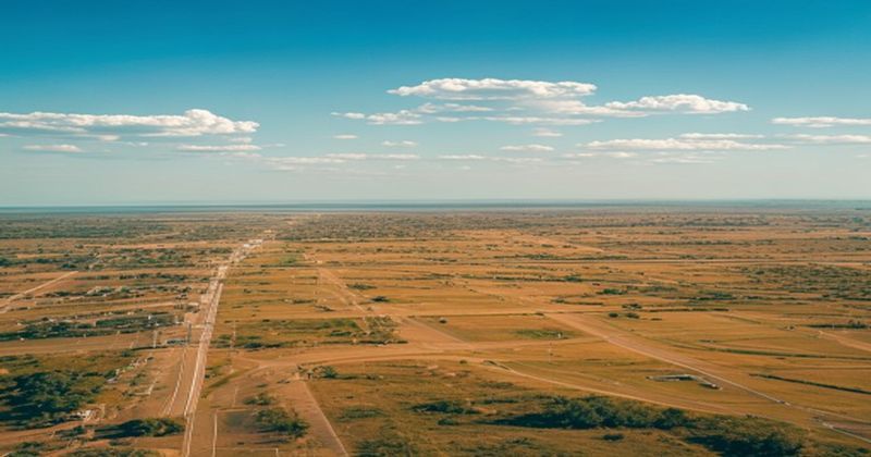 Aerial drone view of a vast undeveloped land parcel adjacent